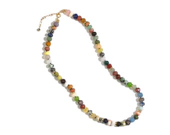 May include: A colorful beaded necklace with a variety of small, round beads in shades of red, orange, yellow, green, blue, and pink. The necklace has gold-colored metal accents and a clasp.