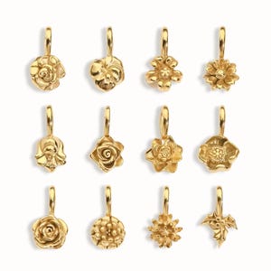 Gold birth flower charm representing each month, featuring a delicate embossed floral design on a round gold pendant — a personalized jewelry gift for her.