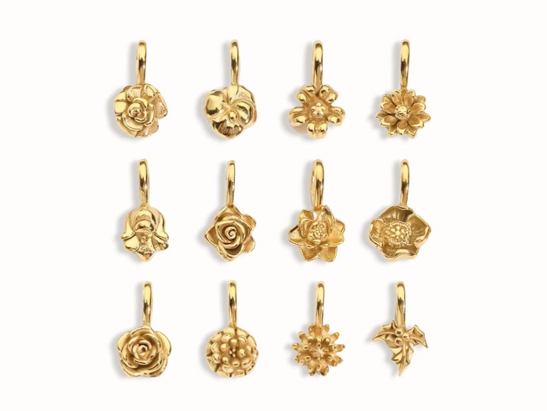 Gold birth flower charm representing each month, featuring a delicate embossed floral design on a round gold pendant — a personalized jewelry gift for her.