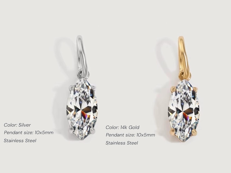 Gold diamond crystal charm displayed on a white background, each featuring a marquise cut The clear faceted stones shimmer in the light, framed in gold settings with looped bails for attaching to necklaces or bracelets. Elegant minimalist photo showing jewelry-making pendants available in both gold and silver options.  Perfect for diy jewelry to use as add-on charms for any charm necklace or charm bracelet.