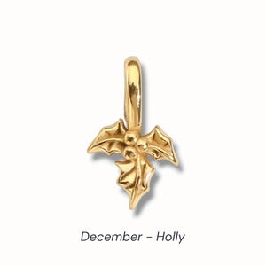Gold birth flower charm representing each month, featuring a delicate embossed floral design on a round gold pendant — a personalized jewelry gift for her.