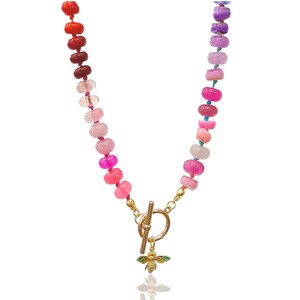 A rainbow multi-gemstone opal necklace that is hand-knotted & handcrafted.  Made from natural semi precious opal gemstones.  This necklace is sure to add a pop of color to any outfit. It features a gold dragonfly pendant.