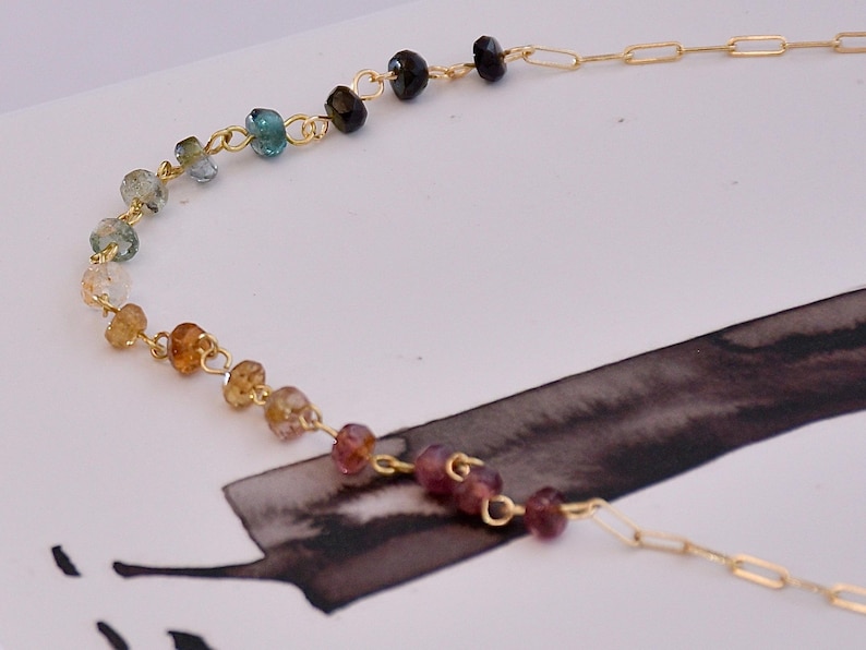 Gorgeous rainbow tourmaline rondelle beaded necklace that is wire wrapped toa 14k gold filled paperclip chain.  Handmade and handcrafted natural gems