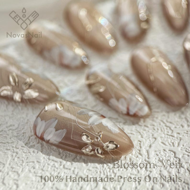 Custom-made neutral press-on nails with cat eye gel effect.