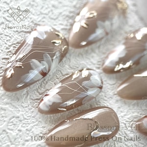 Sophisticated floral nail art with shimmering cat eye base.