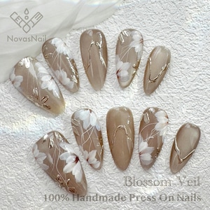Elegant floral press-on nails with sheer cat eye base.