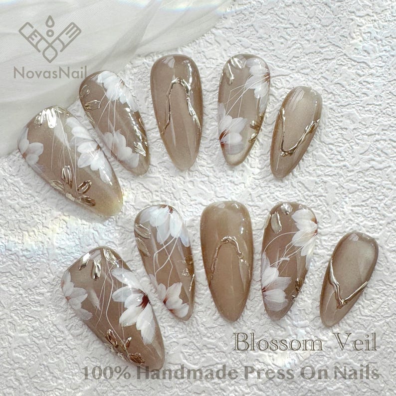 Elegant floral press-on nails with sheer cat eye base.