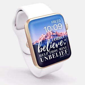 May include: A white Apple Watch with a gold band and a blue and purple mountain scene background. The watch face displays the time 10:09 and the date FRI 23. The text on the watch face reads "LORD, I believe; help thou mine unbelief. Mark 9:24"