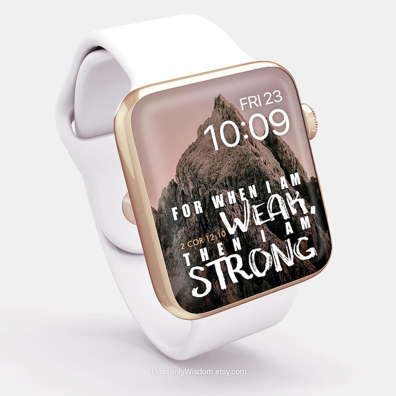 May include: A white smartwatch with a gold-colored bezel displays the time and a mountain image with the text "FOR WHEN I AM WEAK, THEN I AM STRONG" and "2 COR 12:10". The watch band is white.