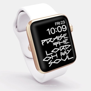 May include: White smartwatch with a gold-colored bezel and a black screen displaying the time, date, and the phrase "Praise the Lord Oh My Soul" in white text. The watch band is white.