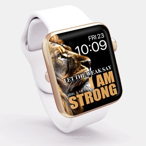 May include: A white Apple Watch with a gold band and a black face. The face features a lion's head with the text "Let the weak say I am strong" and "Joel 3:10". The time is 10:09 and the day is Friday the 23rd.