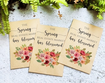 May include: Three brown cards with floral designs and the text "THE Spring REAL ESTATE MARKET has blossomed".