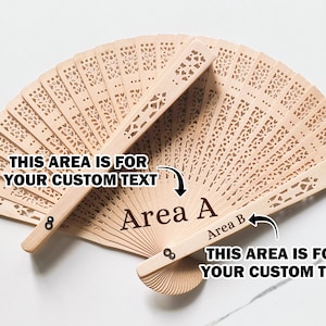 May include: A wooden hand fan with intricate cutouts. The fan has two areas for custom text, labeled "Area A" and "Area B".