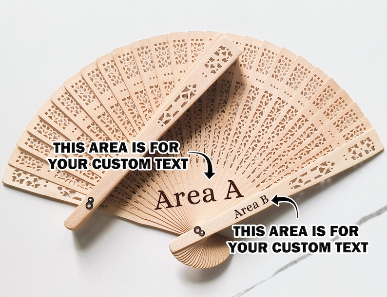 May include: A wooden hand fan with intricate cutouts. The fan has two areas for custom text, labeled "Area A" and "Area B".