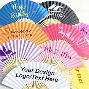 May include: A collection of colorful paper fans with various custom text and logo designs. The fans are in shades of blue, orange, purple, pink, gray, and yellow. Text includes "Happy Birthday", "Sophia", "Mr & Mrs", and "Your Design Logo/Text Here".
