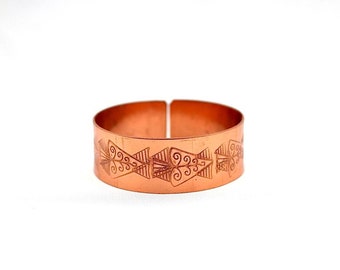 A handmade hammered copper bracelet with a unique design