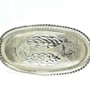 May include: A silver oval serving tray with an embossed design of grapes and vines.