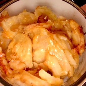 May include: A close-up of a bowl filled with golden brown, caramelized apple slices.