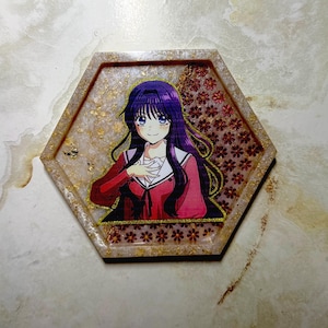 May include: Hexagonal resin tray with a gold flecked design and a cartoon illustration of a girl with purple hair and a red uniform. The tray has a floral pattern on the right side.