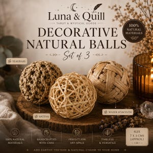May include: A set of three decorative natural balls labelled Luna & Quill. The set includes one seagrass ball, one rattan ball, and one water hyacinth ball. Text on the image indicates 100% natural materials and a size of 7 x 3 cms.
