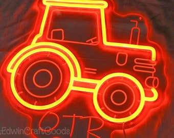 May include: Red neon tractor sign with a yellow outline. The sign has two wheels and a cab. The word "OTR" is written below the tractor.