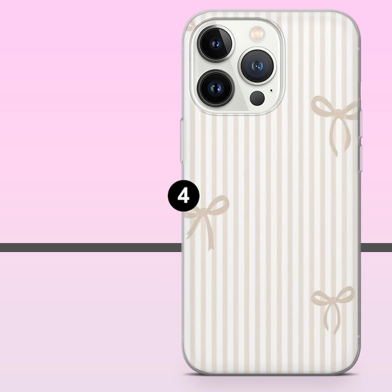 May include: A phone case with a vertical striped pattern in beige and white. The case features several small bow illustrations in a matching beige color. The phone case has a clear border and a camera module with three lenses.