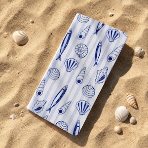 May include: A rectangular tray featuring a light blue and white vertical striped pattern decorated with dark blue illustrations of various seashells, spiral shells, and small fish arranged in a repeating motif across the entire surface.