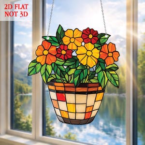 May include: A stained glass window hanging featuring a flower basket design. The basket is filled with orange, yellow, and red flowers with green leaves. The text "2D FLAT NOT 3D" is in the upper left corner. The window is hanging from a chain.