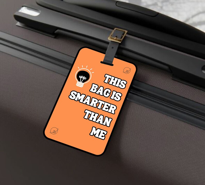 May include: Orange luggage tag with a lightbulb graphic and the text "This bag is smarter than me".