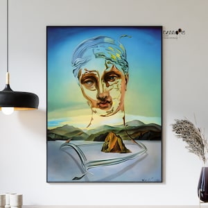 May include: A surrealist painting of a woman's face with a landscape in the background. The woman's face is made up of different shapes and colors, and the landscape is a mix of mountains, water, and sky. The painting is in a black frame.