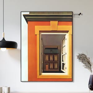 Könnte beinhalten: Gerahmtes Gemälde, das ein Haus in einem Haus zeigt, durch ein Fenster betrachtet. Der äußere Rahmen ist orange und gelb, mit einem Blick auf eine weiße Wand. Das innere Haus ist braun mit einem grünen Dach, wodurch ein geschichteter Effekt entsteht. Das Kunstwerk wird an einer weißen Wand ausgestellt.