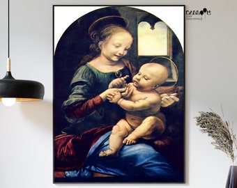 May include: A framed print of a Renaissance painting depicting a woman and a baby. The woman, wearing a dark blue and green dress, is holding a small object. The baby is seated on her lap, with a golden halo around its head. The artwork is set against a dark background.
