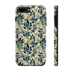 May include: A phone case with a botanical design. The case features a repeating pattern of leaves in shades of yellow, teal, and navy blue against a white background. The side of the case is black.
