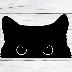 May include: A black silhouette of a cat's face with large, round eyes peeking out from behind a white wooden surface.