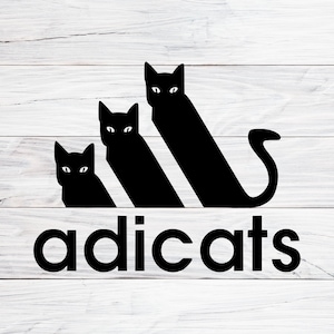 May include: Black and white graphic design of three cats in a triangle formation with the word "adicats" below. The design is reminiscent of the Adidas logo.