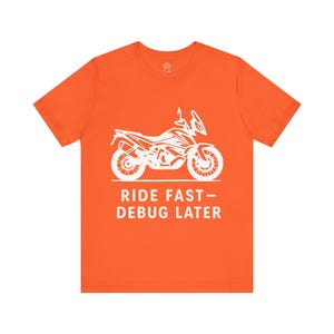 May include: Orange t-shirt with a white silhouette of a motorcycle and the text "Ride Fast - Debug Later".