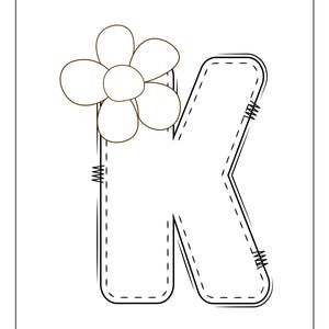 May include: A black and white outline of the letter K with a simple flower design on top. The letter is stylized to look like a patch with stitching details.