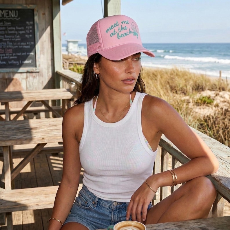 Model wearing light pink 'meet me at the beach' hat for vacation beach hat custom