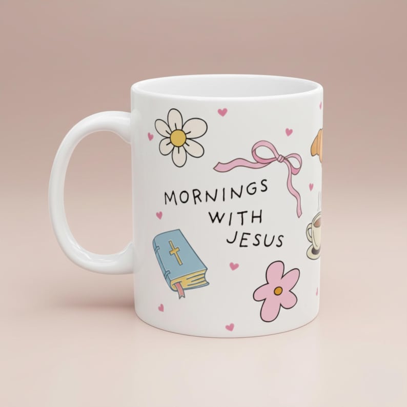 Cute white mug on a blush background with pastel doodle artwork, hand-drawn illustrations of a pink bow, bible, white daisy flower and yellow flower, with small scattered pink hearts, perfect for cozy aesthetic coffee lovers.