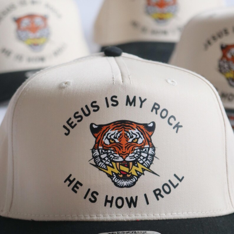 Black Bill and Natural Baseball Hat for Christian with Retro Jesus is My Rock He is How I Roll Message Tiger Design Christian Hat Sports Faith Baseball Cap Christian Design Natural Color Headwear Perfect Mom Gift Teen Essential Black Bill Snapback Closure Tiger and Lightning Bolt Design Christian Baseball Cap for Teen