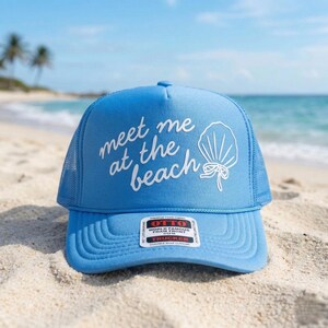 Blue trucker hat with Meet Me at the Beach puff vinyl lettering in script font summer beach accessory casual outdoor fashion
