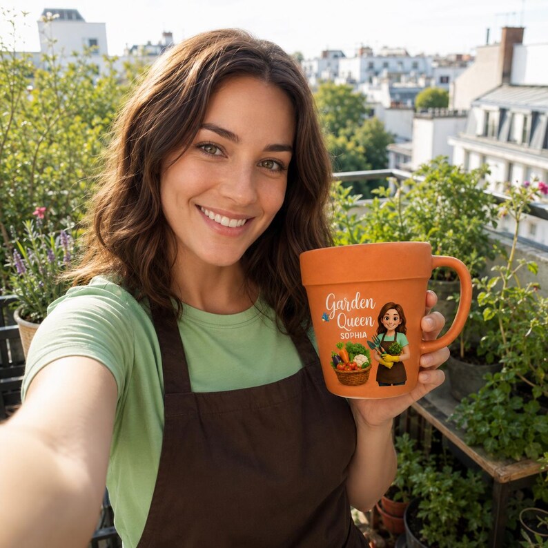 May include: A terracotta-colored ceramic mug shaped like a flower pot, featuring the text Garden Queen and the name Sophia, accompanied by an illustration of a person holding gardening tools next to a basket filled with various fresh vegetables.