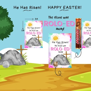 Op de afbeelding: Een afdrukbare paaskaarten met een aquarel-illustratie van een stenen graf. De kaart zegt "Hij is opgestaan! De steen was ROLO-ED weg!" en is versierd met een zon en bloemen. De kaart is ontworpen om te worden gebruikt met een Rolo-chocolade reep.