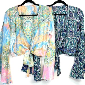 May include: Two long-sleeved, paisley patterned wrap tops. One is a light blue and pink tie-dye pattern, the other is a dark green and blue paisley pattern.