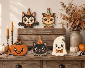 May include: A set of five wooden cutout decorations featuring a black bat with a bow tie, a brown owl with a ruffled collar, an orange pumpkin, a black cat, and a white ghost. Each figure wears a colorful party hat and has large eyes.