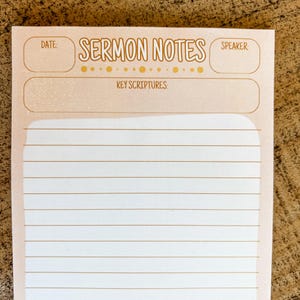 May include: A notepad with the words "SERMON NOTES" in a decorative font. The notepad has sections for date, speaker, and key scriptures, with lined pages for notes. The background is a light peach color.