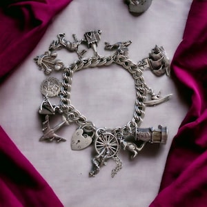 Vintage sterling 925 silver bracelet with 13 charms from EFC. Hallmarked.
