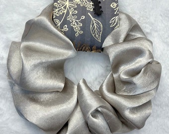 Beautiful Silver Silk Scrunchie features a soft and comfortable hold, keeping your hair secure without causing any discomfort.