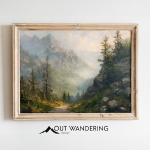 May include: A framed oil painting depicting a mountain landscape with a winding path leading through a forest. The mountains are covered in mist and the sky is a soft blue. The painting is in a light wood frame.