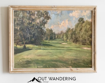 Könnte beinhalten: Ein gerahmtes Ölgemälde, das einen Golfplatz mit grünem Gras, Bäumen und einem blauen Himmel mit weißen Wolken darstellt. Das Gemälde ist in einem hellen Holzrahmen.